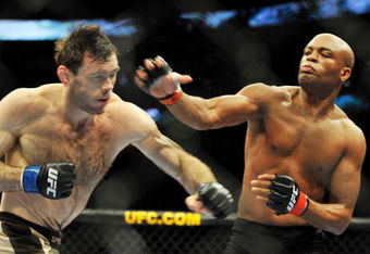 PHILADELPHIA - AUGUST 08:  Anderson Silva (R) throws a right punch to Forrest Griffin during their light heavyweight bout at UFC 101: Declaration at the Wachovia Center on August 8, 2009 in Philadelphia, Pennsylvania.  (Photo by Jon Kopaloff/Getty Images)