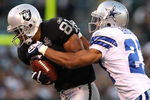 OAKLAND, CA - AUGUST 13: Chaz Schilens #81 of the Oakland Raiders catches a pass over Courtney Brown #27 of the Dallas Cowboys during a preseason game at Oakland-Alameda County Coliseum on August 13, 2009 in Oakland, California.  (Photo by Jed Jacobsohn/Getty Images)