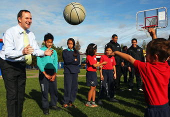 AUCKLAND, NEW ZEALAND - AUGUST 11: New Zealand Prime Minister John Key plays sport with school children at the launch of a new school sports funding initiative from the New Zealand Government at Bairds Mainfreight Primary School, Otara on August 11, 2009 in Auckland, New Zealand. Key announced the Government will spend $82 million over four years getting kids to play school sport.  (Photo by Phil Walter/Getty Images)