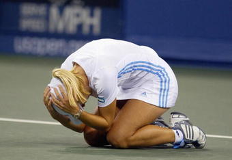 FLUSHING, NY - SEPTEMBER 5:  Justine Henin-Hardenne of Belgium celebrates match point against Jennifer Capriati of the USA during the US Open at the USTA National Tennis Center, Flushing Meadows Corona Park on September 5, 2003 in Flushing, New York. (Photo by Nick Laham/Getty Images)