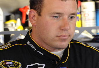 WATKINS GLEN, NY - AUGUST 07:  Ryan Newman, driver of the #39 U.S. Army Chevrolet, stands in the garage during practice for the NASCAR Sprint Cup Series Heluva Good! Sour Cream Dips at Watkins Glen International on August 7, 2009 in Watkins Glen, New York.  (Photo by John Harrelson/Getty Images for NASCAR)