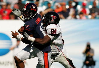 JACKSONVILLE, FL - JANUARY 01:  Jameel Sewell #10 of the Virginia Cavaliers is tackled by Brandon Williams #84 of the Texas Tech Red Raiders during the Gator Bowl at Jacksonville Municipal Stadium on January 1, 2008 in Jacksonville, Florida.  (Photo by Sam Greenwood/Getty Images)