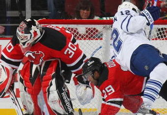 NEWARK, NJ - APRIL 07: Lee Stempniak #12 of the Toronto Maple Leafs is upended by Johnny Oduya #29 of the New Jersey Devils on April 7, 2009 at the Prudential Center in Newark, New Jersey. (Photo by Bruce Bennett/Getty Images)