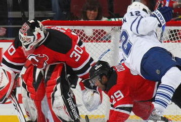 NEWARK, NJ - APRIL 07: Lee Stempniak #12 of the Toronto Maple Leafs is upended by Johnny Oduya #29 of the New Jersey Devils on April 7, 2009 at the Prudential Center in Newark, New Jersey. (Photo by Bruce Bennett/Getty Images)