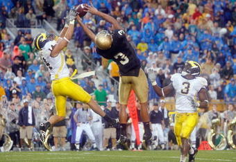 SOUTH BEND,IN - SEPTEMBER 13:  Morgan Trent #14 of the Michigan Wolverines reaches for the ball against Michael Floyd #3 of the Notre Dame Fighting Irish on September 13, 2008 at Notre Dame Stadium in South Bend, Indiana. (Photo by: Gregory Shamus/Getty Images)