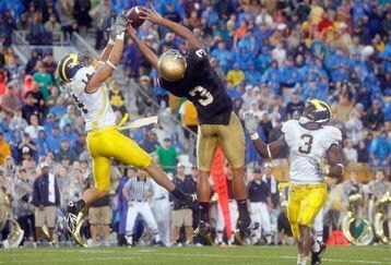 SOUTH BEND,IN - SEPTEMBER 13:  Morgan Trent #14 of the Michigan Wolverines reaches for the ball against Michael Floyd #3 of the Notre Dame Fighting Irish on September 13, 2008 at Notre Dame Stadium in South Bend, Indiana. (Photo by: Gregory Shamus/Getty Images)