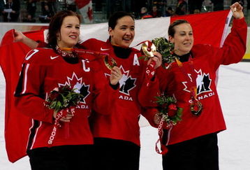TURIN, ITALY - FEBRUARY 20:  (L-R) Cassie Campbell #77, Vicky Sunohara #61 and Jayna Hefford #16 all of Canada celebrate winning the gold medal in women's ice hockey with a 4-1 victory over Sweden during Day 10 of the Turin 2006 Winter Olympic Games on February 20, 2006 at the Palasport Olimpico in Turin, Italy.  (Photo by Brian Bahr/Getty Images)