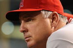 PHOENIX - JUNE 27:  Manager Mike Scioscia of the Los Angeles Angels of Anaheim watches from the dugout during the major league baseball game against the Arizona Diamondbacks at Chase Field on June 27, 2009 in Phoenix, Arizona. The Angels defeated the Diamondbacks 2-1.  (Photo by Christian Petersen/Getty Images)