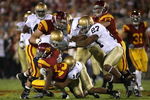 LOS ANGELES, CA - NOVEMBER 29:  Runningback Stafon Johnson #13 of the USC Trojans is tackled by the Notre Dame Fighting Irish during the game at Los Angeles Memorial Coliseum on November 29, 2008 in Los Angeles, California. The Trojans defeated the Fighting Irish 38-3.  (Photo by Christian Petersen/Getty Images)