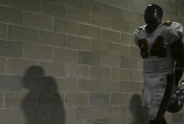 TAMPA, FL - SEPTEMBER 24:  Running back Carnell Williams #24 and punter Josh Bidwell #9 of the Tampa Bay Buccaneers make their way back to the locker room after losing a late lead to the Carolina Panthers on September 24, 2006 at Raymond James Stadium in Tampa, Florida. The Panthers defeated the Buccaneers 26-24.  (Photo by Doug Benc/Getty Images)