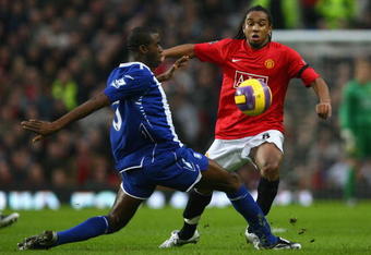 MANCHESTER, UNITED KINGDOM - JANUARY 01:  Anderson of Manchester United is challenged by Fabrice Muamba of Birmingham City during the Barclays Premier League match between Manchester United and Birmingham City at Old Trafford on January 1, 2008 in Manchester, England.  (Photo by Alex Livesey/Getty Images)