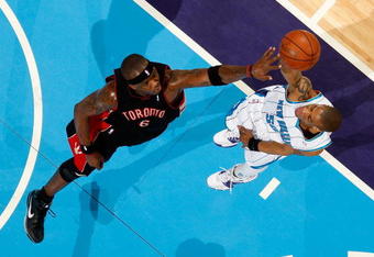 NEW ORLEANS - FEBRUARY 06:  Antonio Daniels #50 of the New Orleans Hornets makes a shot over Jermaine O'Neal #6 of the Toronto Raptors on February 6, 2009 in New Orleans, Louisiana.  NOTE TO USER: User expressly acknowledges and agrees that, by downloading and/or using this Photograph, user is consenting to the terms and conditions of the Getty Images License Agreement.  (Photo by Chris Graythen/Getty Images)