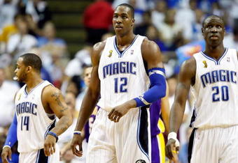 ORLANDO, FL - JUNE 14:  (C) Dwight Howard #12 of the Orlando Magic walks between teammates Jameer Nelson #14 and Mickael Pietrus #20 of the Magic in the second quarter of Game Five of the 2009 NBA Finals against the Los Angeles Lakers on June 14, 2009 at Amway Arena in Orlando, Florida.  NOTE TO USER:  User expressly acknowledges and agrees that, by downloading and or using this photograph, User is consenting to the terms and conditions of the Getty Images License Agreement.  (Photo by Ronald Martinez/Getty Images)