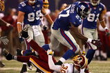EAST RUTHERFORD, NJ - SEPTEMBER 04:  Brandon Jacobs #27 of the New York Giants runs through the tackle of LaRon Landry #30 of the Washington Redskins at Giants Stadium on September 4, 2008 in East Rutherford, New Jersey  (Photo by Al Bello/Getty Images)