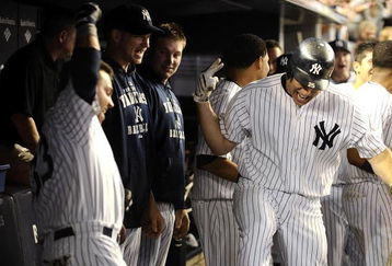 NEW YORK - AUGUST 09:  Mark Teixeira #25 of the New York Yankees is greeted by teammates after hitting a solo home run in the eighth inning against the Boston Red Sox during their game on August 9, 2009 at Yankee Stadium in the Bronx Borough of New York City.  (Photo by Jeff Zelevansky/Getty Images)