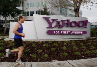 SUNNYVALE, CA - JANUARY 22:  A jogger runs by the Yahoo logo on a sign outside of the Yahoo Sunnyvale campus January 22, 2008 in Sunnyvale, California. Yahoo is poised to lay off hundreds of employees in hopes of increasing profits and boosting its stock price. No date is set for the layoffs but it is likely that the notice will come around January 29th when the company reports quarterly earnings.  (Photo by Justin Sullivan/Getty Images)