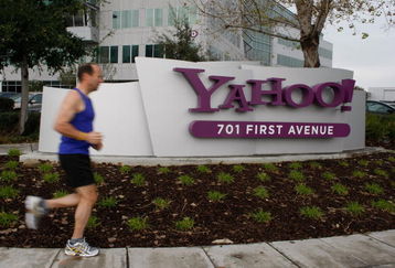 SUNNYVALE, CA - JANUARY 22:  A jogger runs by the Yahoo logo on a sign outside of the Yahoo Sunnyvale campus January 22, 2008 in Sunnyvale, California. Yahoo is poised to lay off hundreds of employees in hopes of increasing profits and boosting its stock price. No date is set for the layoffs but it is likely that the notice will come around January 29th when the company reports quarterly earnings.  (Photo by Justin Sullivan/Getty Images)