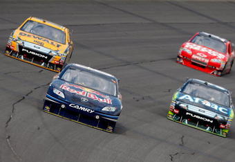 BROOKLYN, MI - AUGUST 16:  Brian Vickers (C), driver of the #83 Red Bull Toyota, leads Matt Kenseth (L), driver of the #17 DEWALT FORD, Carl Edwards (R), driver of the #99 AFLAC Ford and Tony Stewart, driver of the #14 Office Depot Chevrolet, during the NASCAR Sprint Cup Series CARFAX 400 at Michigan International Speedway on August 16, 2009 in Brooklyn, Michigan.  (Photo by Jason Smith/Getty Images)