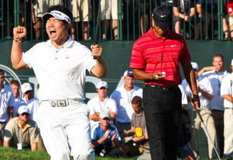 CHASKA, MN - AUGUST 16:  (L-R) Y.E. Yang of South Korea celebrates a birdie putt on the 18th green alongside Tiger Woods during the final round of the 91st PGA Championship at Hazeltine National Golf Club on August 16, 2009 in Chaska, Minnesota.  (Photo by David Cannon/Getty Images)