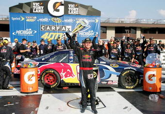 BROOKLYN, MI - AUGUST 16:  Brian Vickers, driver of the #83 Red Bull Toyota, celebrates with his crew in victory lane after winning the NASCAR Sprint Cup Series CARFAX 400 at Michigan International Speedway on August 16, 2009 in Brooklyn, Michigan.  (Photo by Jerry Markland/Getty Images for NASCAR)