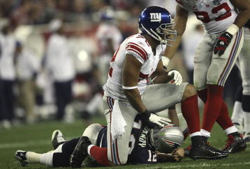 GLENDALE, AZ - FEBRUARY 03:  Defensive end Osi Umenyiora #72 of the New York Giants sits on Tom Brady #12 of the New England Patriots in the second quarter of Super Bowl XLII on February 3, 2008 at the University of Phoenix Stadium in Glendale, Arizona.  (Photo by Elsa/Getty Images)