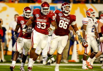 MIAMI - JANUARY 08:  (L-R) Keenan Calhoun #22, Gerald McCoy #93 and Adrian Taylor #86 of the Oklahoma Sooners celebrate a defensive stop against the Florida Gators during the FedEx BCS National Championship game at Dolphin Stadium on January 8, 2009 in Miami, Florida.  (Photo by Marc Serota/Getty Images)