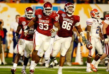 MIAMI - JANUARY 08:  (L-R) Keenan Calhoun #22, Gerald McCoy #93 and Adrian Taylor #86 of the Oklahoma Sooners celebrate a defensive stop against the Florida Gators during the FedEx BCS National Championship game at Dolphin Stadium on January 8, 2009 in Miami, Florida.  (Photo by Marc Serota/Getty Images)