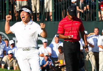 CHASKA, MN - AUGUST 16:  (L-R) Y.E. Yang of South Korea celebrates a birdie putt on the 18th green alongside Tiger Woods during the final round of the 91st PGA Championship at Hazeltine National Golf Club on August 16, 2009 in Chaska, Minnesota.  (Photo by David Cannon/Getty Images)