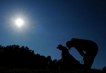 CHASKA, MN - AUGUST 16:  Tiger Woods (R) reacts to his tee shot on the 17th hole as caddie Steve Williams walks off during the final round of the 91st PGA Championship at Hazeltine National Golf Club on August 16, 2009 in Chaska, Minnesota.  (Photo by Stuart Franklin/Getty Images)