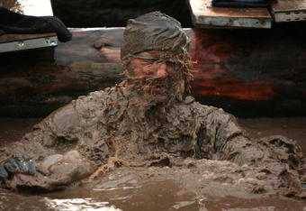 WOLVERHAMPTON, ENGLAND - FEBRUARY 01:  A competitor gasps for air after emerging from an underwater obstacle during the Tough Guy Challenge 2009 at South Perton Farm on February 1, 2009 in Wolverhampton, England. The biannual event to raise cash for charity challenges thousands of international competitors to run through a gruelling set of 21 obstacles including water, fire and tunnels after a lengthy run at the start.  (Photo by Christopher Furlong/Getty Images)