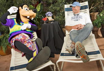 LAKE BUENA VISTA, FL - FEBRUARY 28:  In this handout photo provided by Disney , Brett Favre, who recently announced his retirement, lounges with Goofy on February 28, 2009 at Walt Disney World Resort in Lake Buena Vista, Florida. Favre, who holds multiple NFL records including most passing yards in a career, is at Walt Disney World this weekend for 'ESPN The Weekend,' a sports-themed fan event held at Disney's Hollywood Studios theme park.  (Photo by Matt Stroshane/Disney Via Getty Images)