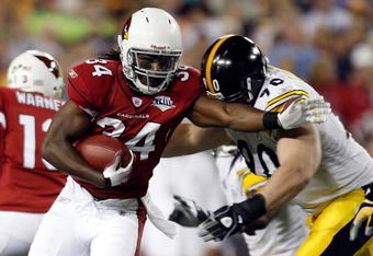 TAMPA, FL - FEBRUARY 01:  Running back Tim Hightower #34 of the Arizona Cardinals runs the ball and attempts to get by defensive end Travis Kirschke #90 of the Pittsburgh Steelers during Super Bowl XLIII on February 1, 2009 at Raymond James Stadium in Tampa, Florida.  (Photo by Streeter Lecka/Getty Images)