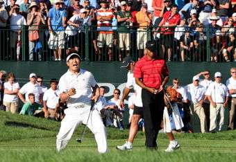 CHASKA, MN - AUGUST 16:  (L-R) Y.E. Yang of South Korea celebrates a birdie putt on the 18th green alongside Tiger Woods during the final round of the 91st PGA Championship at Hazeltine National Golf Club on August 16, 2009 in Chaska, Minnesota.  (Photo by David Cannon/Getty Images)
