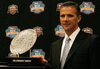 FORT LAUDERDALE, FL - JANUARY 07:  Head coach Urban Meyer of the Florida Gators poses with the 'The Coaches' Trophy' during the FedEx BCS Head Coaches Press Conference at Harbor Beach Marriott Resort & Spa on January 7, 2009 in Fort Lauderdale, Florida.  (Photo by Doug Benc/Getty Images)