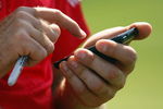 CHASKA, MN - AUGUST 11:  Ian Poulter of England uses his phone during the second preview day of the 91st PGA Championship at Hazeltine National Golf Club on August 11, 2009 in Chaska, Minnesota.  (Photo by Scott Halleran/Getty Images)