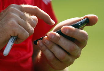 CHASKA, MN - AUGUST 11:  Ian Poulter of England uses his phone during the second preview day of the 91st PGA Championship at Hazeltine National Golf Club on August 11, 2009 in Chaska, Minnesota.  (Photo by Scott Halleran/Getty Images)