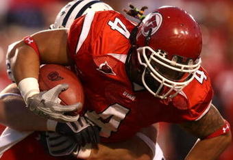 SALT LAKE CITY - NOVEMBER 22:  Matt Asiata #4 of the Utah Utes runs with the ball against the BYU Cougars at Rice-Eccles Stadium on November 22, 2008 in Salt Lake City, Utah.  (Photo by Jonathan Ferrey/Getty Images)