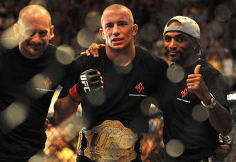 LAS VEGAS - JULY 11:  (2nd R) Georges St. Pierre celebrates his victory against Thiago Alves during their welterweight title bout during UFC 100 on July 11, 2009 in Las Vegas, Nevada. St. Pierre defeated Alves by unanimous decision.  (Photo by Jon Kopaloff/Getty Images)