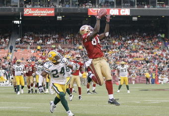 SAN FRANCISCO - AUGUST 16:  Wide receiver Josh Morgan #84 of the San Francisco 49ers catches a 22-yard pass over defensive back Jarrett Bush #24 of the Green Bay Packers during a preseason game at Candlestick Park on August 16, 2008 in San Francisco, California. San Francisco won 34 to 6.  (Photo by Greg Trott/Getty Images)