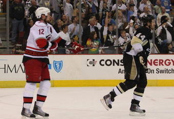 PITTSBURGH - MAY 18:  Eric Staal #12 of the Carolina Hurricanes puts the stick into the back of Brooks Orpik #44 of the Pittsburgh Penguins moments after Game One of the Eastern Conference Championship Round of the 2009 Stanley Cup Playoffs on May 18, 2009 at Mellon Arena in Pittsburgh, Pennsylvania.  (Photo by Bruce Bennett/Getty Images)