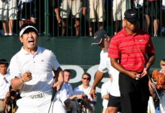 CHASKA, MN - AUGUST 16:  (L-R) Y.E. Yang of South Korea celebrates a birdie putt on the 18th green alongside Tiger Woods during the final round of the 91st PGA Championship at Hazeltine National Golf Club on August 16, 2009 in Chaska, Minnesota.  (Photo by David Cannon/Getty Images)