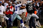 OAKLAND, CA - AUGUST 13:  Running back Darren McFadden #20 of the Oakland Raiders gives a stiff arm during a second quarter run against Courtney Brown #27 of the Dallas Cowboys during the preseason game at Oakland-Alameda County Coliseum on August 13, 2009 in Oakland, California. (Photo by Jed Jacobsohn/Getty Images)