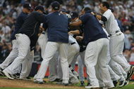 NEW YORK - AUGUST 12:  Members of the New York Yankees celebrate on the mound after Robinson Cano #24 hit a walk-off RBI single in the eleventh inning during the game against the Toronto Blue Jays on August 12, 2009 at Yankee Stadium in the Bronx Borough of New York City. (Photo by Jared Wickerham/Getty Images)