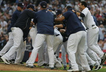 NEW YORK - AUGUST 12:  Members of the New York Yankees celebrate on the mound after Robinson Cano #24 hit a walk-off RBI single in the eleventh inning during the game against the Toronto Blue Jays on August 12, 2009 at Yankee Stadium in the Bronx Borough of New York City. (Photo by Jared Wickerham/Getty Images)
