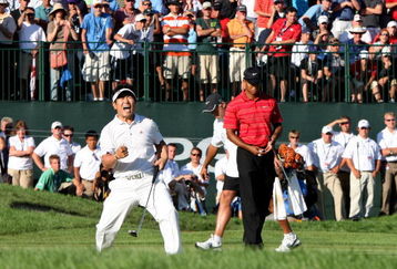 CHASKA, MN - AUGUST 16:  (L-R) Y.E. Yang of South Korea celebrates a birdie putt on the 18th green alongside Tiger Woods during the final round of the 91st PGA Championship at Hazeltine National Golf Club on August 16, 2009 in Chaska, Minnesota.  (Photo by David Cannon/Getty Images)