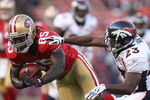 SAN FRANCISCO - AUGUST 14: Tight End Vernon Davis #85 of the San Francisco 49ers catches a pass over Renaldo Hill #23 of the Denver Broncos during the preseason game on August 14, 2009 at Candlestick Park in San Francisco, California. (Photo by Jed Jacobsohn/Getty Images)