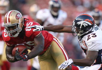 SAN FRANCISCO - AUGUST 14: Tight End Vernon Davis #85 of the San Francisco 49ers catches a pass over Renaldo Hill #23 of the Denver Broncos during the preseason game on August 14, 2009 at Candlestick Park in San Francisco, California. (Photo by Jed Jacobsohn/Getty Images)