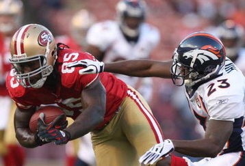 SAN FRANCISCO - AUGUST 14: Tight End Vernon Davis #85 of the San Francisco 49ers catches a pass over Renaldo Hill #23 of the Denver Broncos during the preseason game on August 14, 2009 at Candlestick Park in San Francisco, California. (Photo by Jed Jacobsohn/Getty Images)
