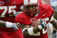 RALEIGH, NC - SEPTEMBER 27:  Tailback Josh Brown #26 of the North Carolina State University Wolfpack carries the ball against the University of North Carolina Tar Heels during the game at Carter Finley Stadium on September 27, 2003 in Raleigh, North Carolina.  N.C. State defeated UNC 47-34.  (Photo by Craig Jones/Getty Images)