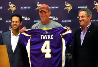 EDEN PRAIRIE, MN - AUGUST 18: Brett Favre (C), Mark Wilf (L) and Zygi Wilf show the media Favre's Minnesota Vikings jersey on August 18, 2009 at Winter Park in Eden Prairie, Minnesota. (Photo by Scott A. Schneider/Getty Images)